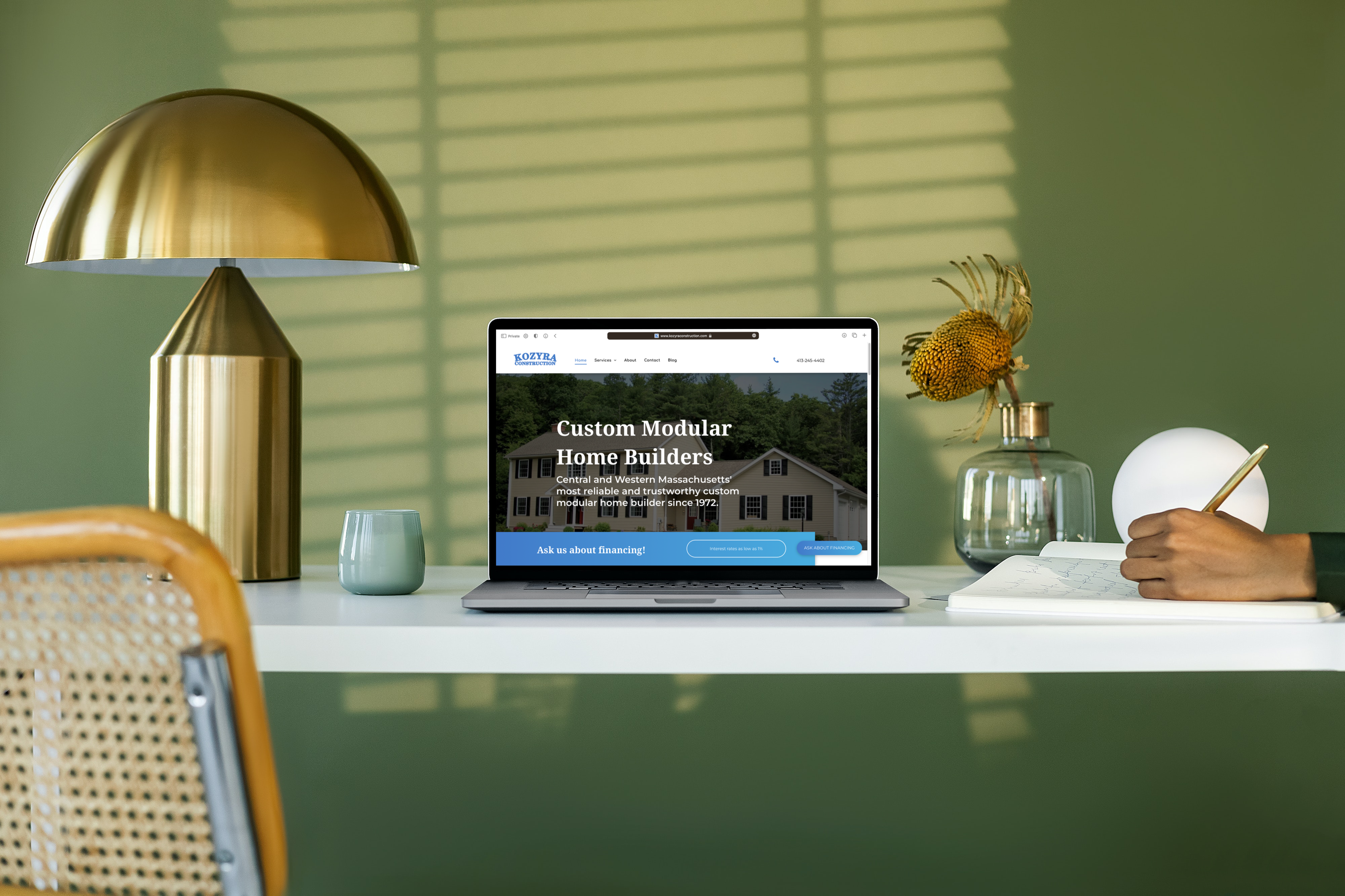 Photo with laptop showing a website.