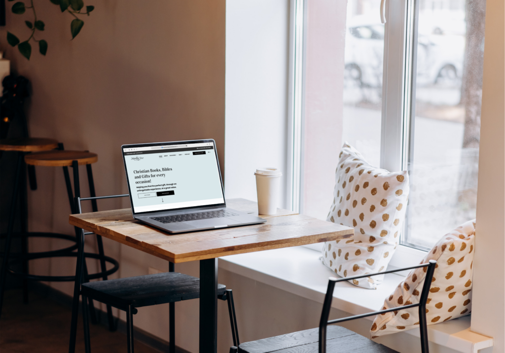 Photo of a laptop on a table at a coffee shop.